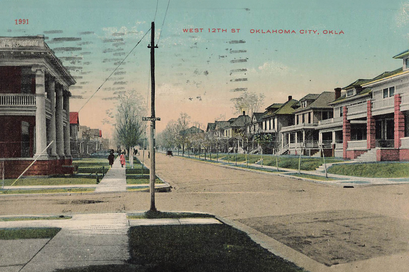A street with houses and a street sign. Historic photo taken at NW 12th and Harvey.