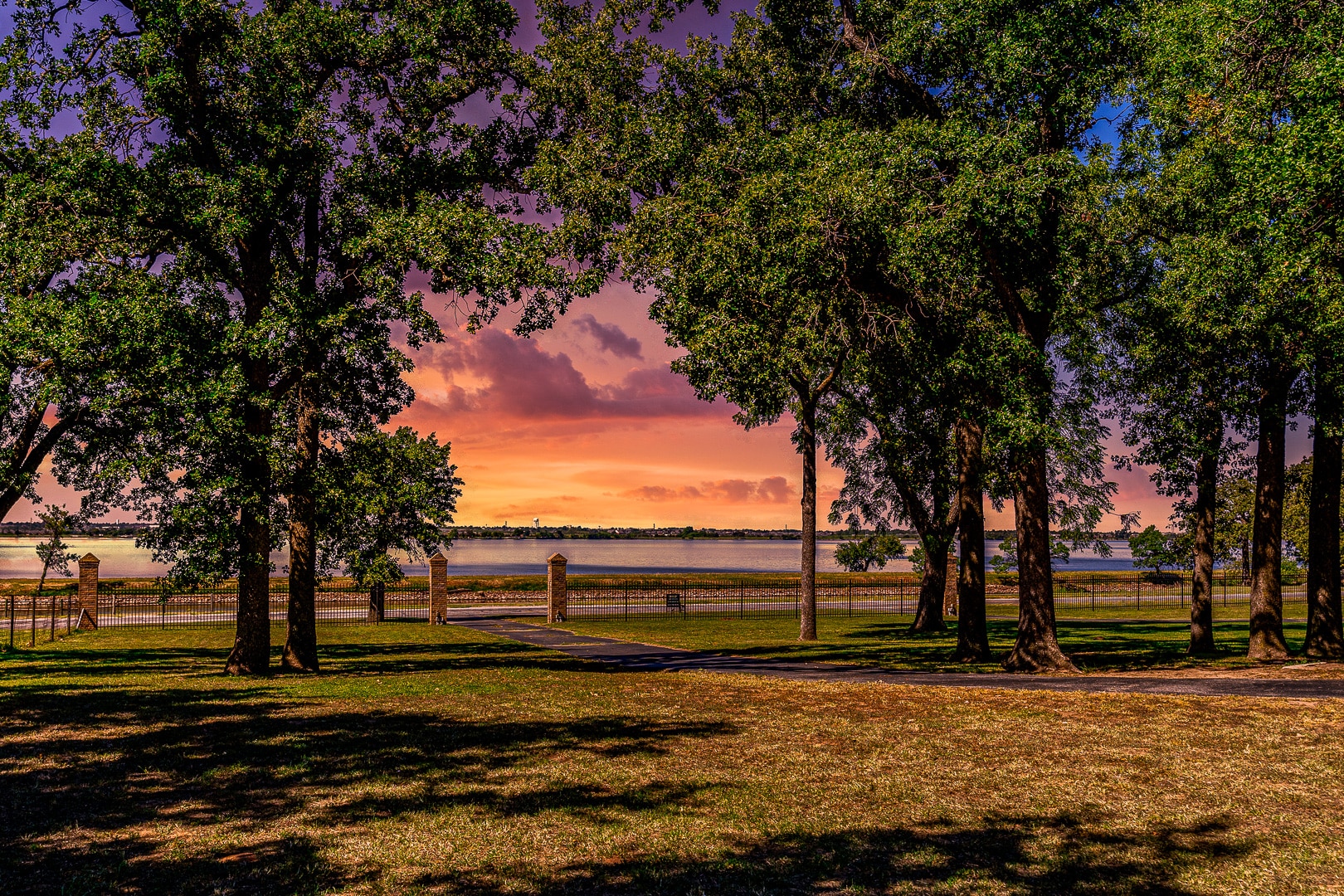This 'lake-view' home will soon become your 'happy place.' This ranch-style home is on 1.5 acres directly in front of Lake Overholser. First impressions count! You'll be impressed with the curb appeal as soon as you drive up. There's a wide, covered front porch where you can sit and enjoy the amazing views of spectacular sunsets on the lake. The large living room has a great view of the lake and a cozy fireplace. You'll appreciate the new luxury vinyl plank flooring in the main living areas. The kitchen has been updated with quartz counters. The large enclosed porch in the back adds lots of extra living space. Off the master suite, there's a large 16x16' deck for enjoying the private backyard. There's also a two-car garage plus a detached four-car garage or shop with spray foam insulation, sheetrock walls, and an overhead heater &amp; window cooling. You'll feel like you're in the country but have quick access to Bethany, Yukon, and the turnpike.
