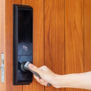 Man opening a door with a smart lock.