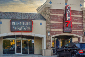 A black car parked in front of Cafe 7