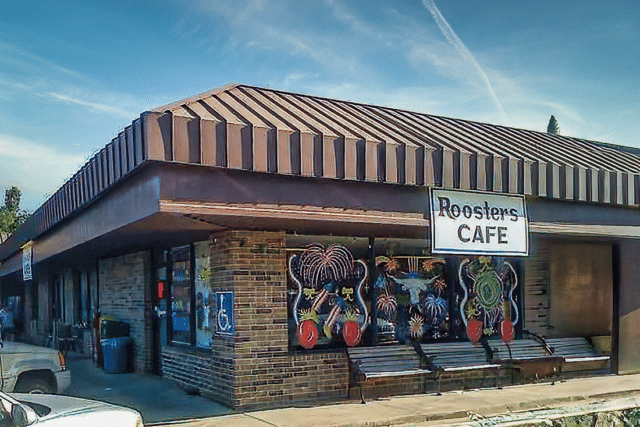 Rooster's cafe with their sign on the side of the building.