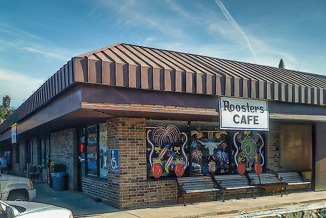 Rooster's cafe with their sign on the side of the building.