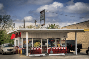 A car parked in front of Tim's Drive Inn diner.