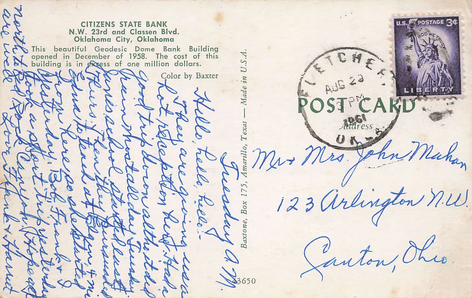 A postcard with a handwritten note on it.