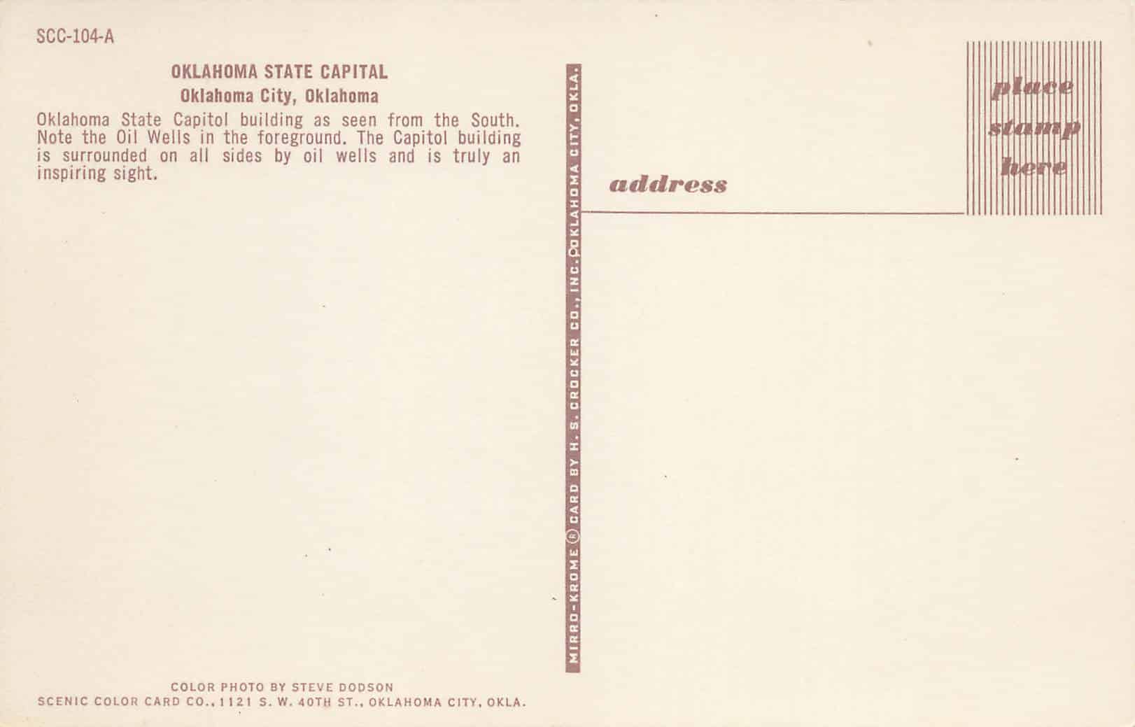 Postcard back that states that the capitol is surrounded on all sides by oil wells.
