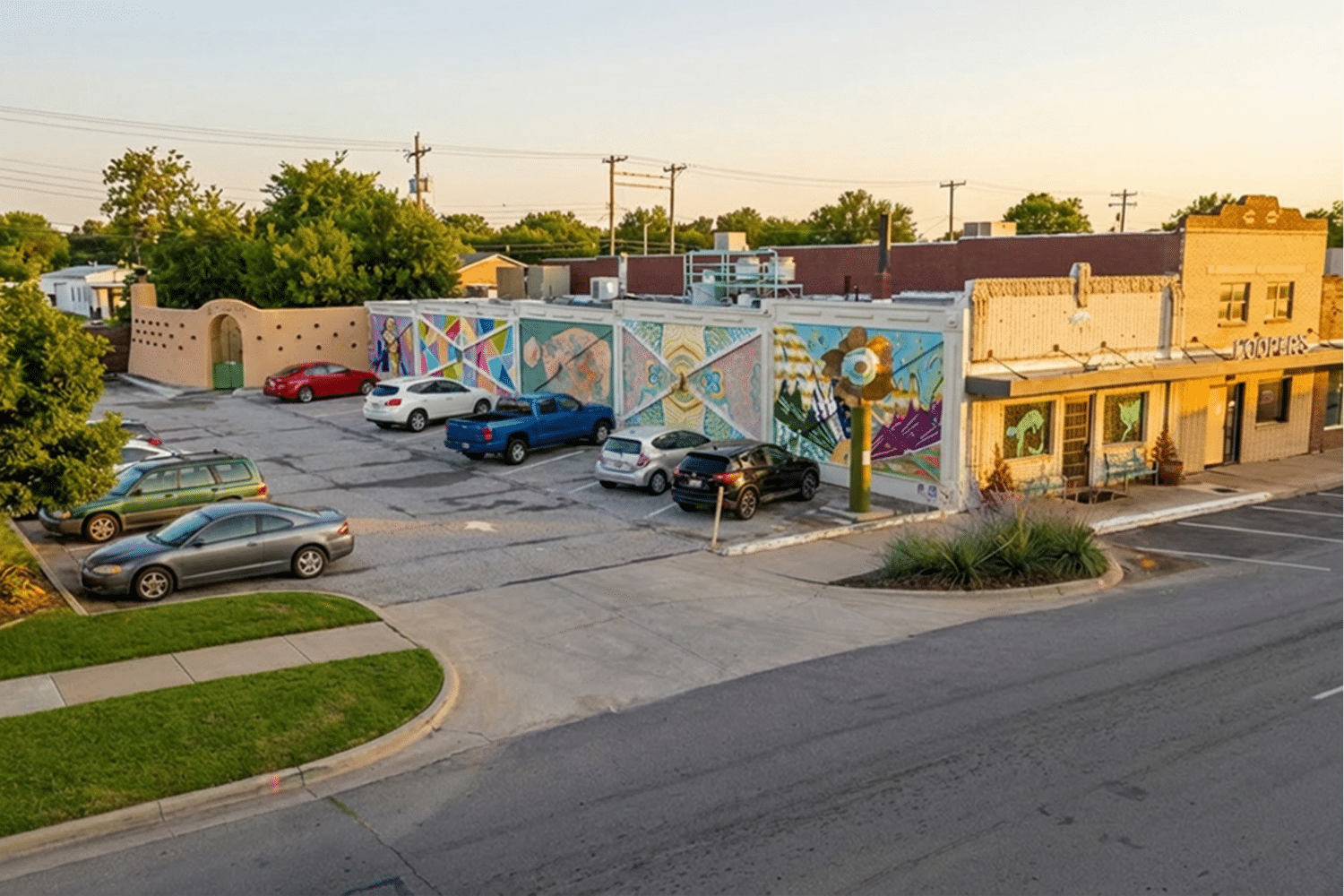 Exterior of El Coyote New Mexican Cuisine and Cantina with colorful mural and parking area